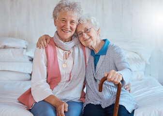 Senior friends, portrait and happy smile, hug and support on a bed in a retirement house, love and care. Elderly women, happiness and connection together in nursing home bedroom in life or friendship