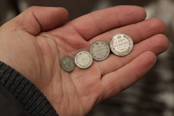 Small silver money of Russian Empire in hand