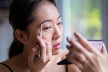Asian Woman Doing Makeup At Home