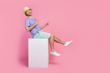 Sticker - Full size photo of handsome young guy sit shopping billboard direct empty space dressed trendy blue look isolated on pink color background