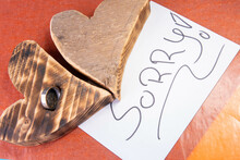 Wooden Heart With Ring And A Letter With Sorry