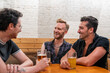 © Brett Edwards/Adobe Stock - LGBTQ Friends sit at a bar with beer and champagne