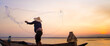 © Thasist - Silhouette of traditional fishermen throwing net fishing lake at sunrise time.(The casting people living along the River)