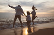 Happy family at sunset on beach travel, Parents playing with child on beach, Family on beach holiday vacation, Freedom and travel concept