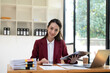 © wichayada - Asian Business woman using calculator and laptop for doing math finance on an office desk, tax, report, accounting, statistics, and analytical research concept