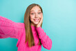 Closeup photo of cute positive sweet blonde hair girl toothy smiling hold phone shooting surprised high quality video isolated on blue color background