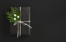 Black Gift Box With White Ribbon And Thuja On Black Background With Space For Your Text