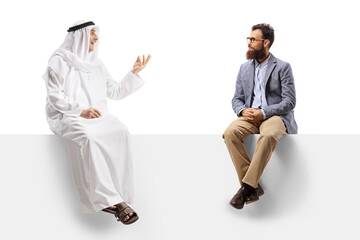 Poster - Arab man in an ethinc robe talking to a casual bearded man seated on a white board