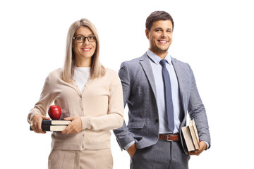 Canvas Print - Smiling male and female teacher holding books