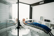 Relaxed woman enjoying in pressotherapy treatment at wellness center or clinic. wide angle