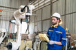 © FotoArtist - Robotics engineer working on maintenance of modern robotic arm in factory warehouse