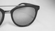 © LiszewskiPhotography - Dark sunglasses isolated on white background. Black and white photo.