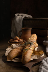 Canvas Print - Homemade bread still life and herbs at wood table. Bread on wooden tabletop