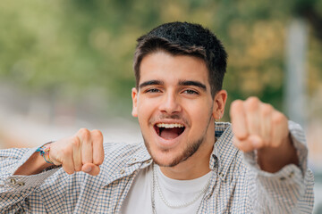 portrait of young man excited with joy celebrating success