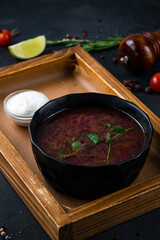 Sticker - Russian borscht soup made from beets, potatoes, cabbage, onions and spices with sour cream and bread on a wooden board.