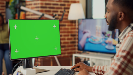 Poster - buisnessman analyzing greenscreen display on monitor, looking at isolated template on pc and working