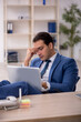 © Elnur - Young male employee working in the office