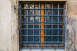 Ground floor window with wrought iron bars. Background or backdrop. Detail or element of classic retro vintage exterior