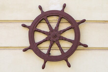 Old Steering Wheel From A Ship On The Wall Of A House, An Element Of Naval Architecture