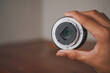 © wdnld - close up of a person holding a camera lens