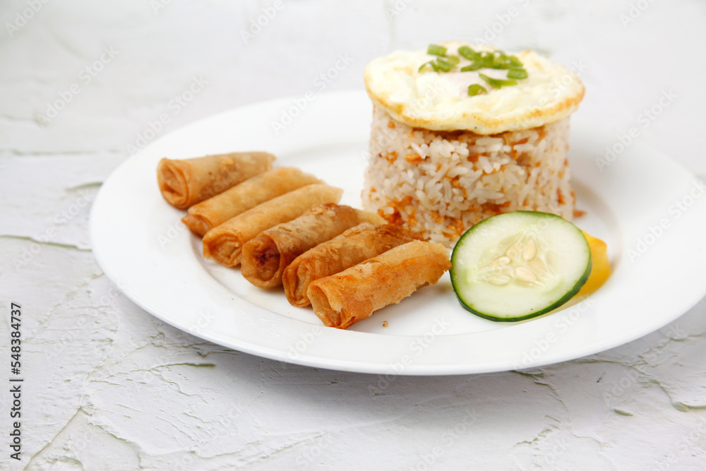 Freshly cooked Filipino food called Shanghai Silog or fried spring roll, egg and fried rice