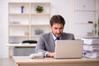 © Elnur - Young male employee and too much work in the office