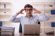 © Elnur - Young male employee and too much work in the office
