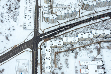Wall Mural - aerial top view of winter cityscape with road intersection and cars traffic. drone photo.