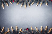  A Christmas Tree Branch With Ornaments On It And A Gray Background With A White Border Around It And A Red Bauble