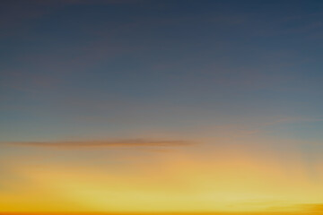 Wall Mural - The dramatic colors of the sunset in the sky gradient from blue to orange.