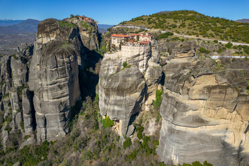 Aerial drne view of Varlaam  monastery, an unesco world heritage site,  located on a unique rock formation  above the village of Kalambaka during fall season.