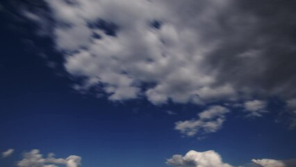 Wall Mural - clouds in the blue sky on a summer day timelapse