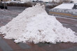 A huge pile of white street snow in the center of Moscow