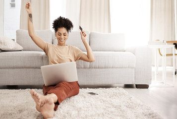 Poster - Black woman, laptop and happy with credit card, ecommerce and approved loan in lounge. Young female, lady and digital device for success, online banking and happiness with smile, joy and living room.