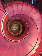 Canvas Print - High angle shot of a pink spiral staircase