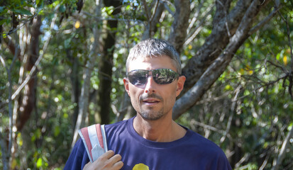 Sticker - Portrait of a happy caucasian man during a hike in the forest