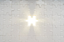 Solution Concept. Soft Sun Light Ray Coming Through Under A Missing Piece Of Jigsaw Puzzle
