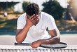 Loser, tennis and black man fitness, for game and losing with headache outdoor on court. Mental health, African American male and athlete with stress, workout and bad training after frustrated match.