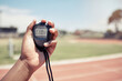 © L Ismail/peopleimages.com - Sport, coach and closeup of hand with stopwatch for time, training and speed of athlete, runner or race. Mentor, trainer and digital clock, watch or timer for fast running on track, field or stadium