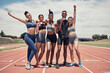© L Ismail/peopleimages.com - Group portrait, sports medals and people at stadium after winning running race or event outdoors. Winner, award and diversity of athletes happy with goals, target or victory achievement on field.