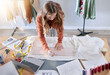 © J Maas/peopleimages.com - Fashion, designer and fabric woman with sewing tools, measuring tape and laptop for manufacturing, production and retail process. Creative, startup and textile industry worker with clothes pattern
