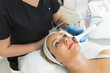 © PoppyPix - blond Caucasian woman lying on a table and getting a face massage by a professional, spa center closeup shot beauty treatment. High quality photo
