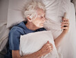 Bad vision, senior woman and phone on bed in bedroom home texting, social media or internet browsing. Blurred eyesight, retired and elderly female with smartphone squinting and trying to read message