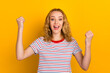© Tetiana - Portrait of shouting in winning with raised fists young girl wearing shirt clothes isolated on bright color background
