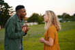 © StratfordProductions - Young multiracial couple face to face shouting and gesturing in field