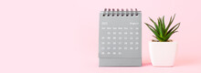 Flip Paper Calendar And Succulent On Pink Background With Space For Text