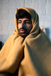 © WESTOCK - close up shot of Shivering young man woke up at night due to viral fever at night on bedroom during winter - concept of sick, fever and unwell.