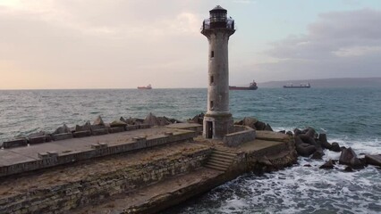 Wall Mural - flying around the lighthouse on a drone early in the morning at sunrise