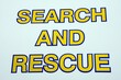 © arenaphotouk - Blue and yellow Search and Rescue words against a white background, Sidmouth, Devon, UK, Europe