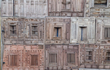 Old wooden windows hidden in traditional texture and background.